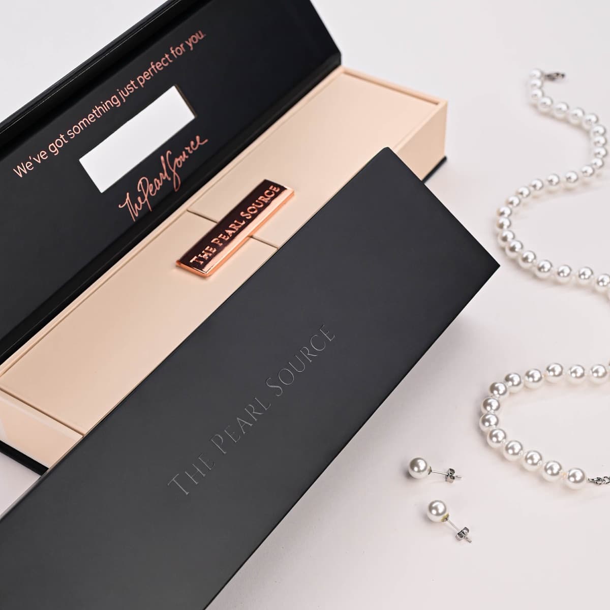 The Pearl Source — custom necklace box with rose gold metal hardware and branded closure